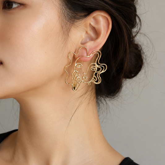 gold-toned face stud earrings